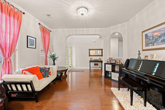 living area with a healthy amount of sunlight and hardwood / wood-style floors