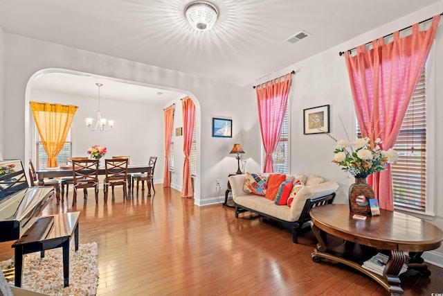 3000 Chesterwood Ct, Myrtle Beach, SC 29579 - living area with arched walkways, a chandelier, light wood-style flooring, and plenty of natural light