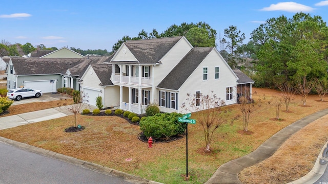 view of front of home featuring a balcony, a garage, and covered porch