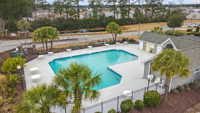 community pool featuring fence and a patio