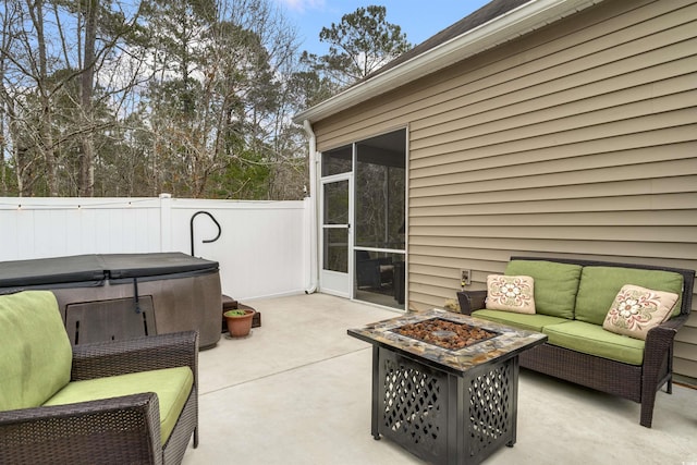 view of patio featuring a fenced backyard and an outdoor living space with a fire pit