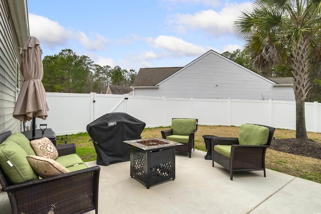 view of patio / terrace with an outdoor living space with a fire pit, a fenced backyard, grilling area, and a gate