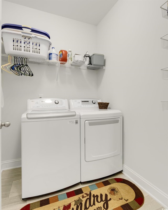 laundry room featuring laundry area, independent washer and dryer, and baseboards