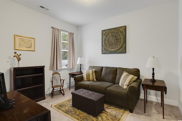 living area featuring light carpet, baseboards, and visible vents