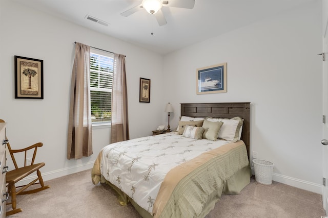 bedroom featuring baseboards, ceiling fan, visible vents, and light colored carpet