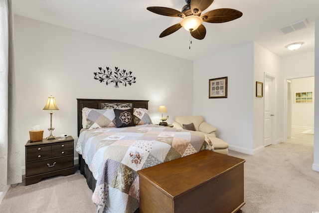 bedroom with a ceiling fan, visible vents, light carpet, and baseboards