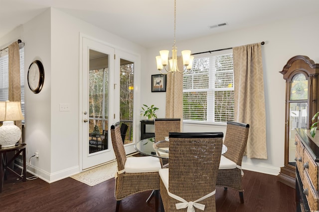 dining space featuring baseboards, visible vents, and dark wood finished floors