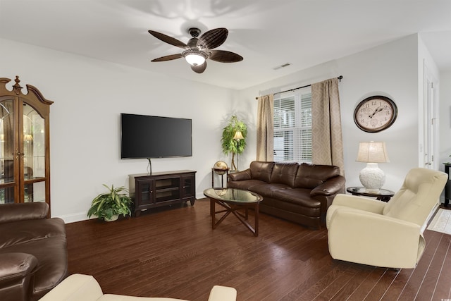 living room with a ceiling fan, dark wood-style flooring, visible vents, and baseboards