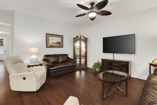 living area featuring dark wood-style floors, ceiling fan, and baseboards