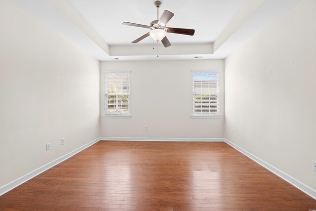 1537 Beaumont Way, Myrtle Beach, SC 29577 - empty room featuring a raised ceiling, hardwood / wood-style floors, ceiling fan, and baseboards