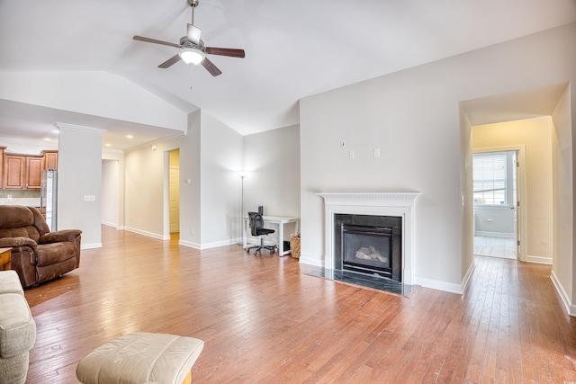 living room with ceiling fan, lofted ceiling, and light hardwood / wood-style floors