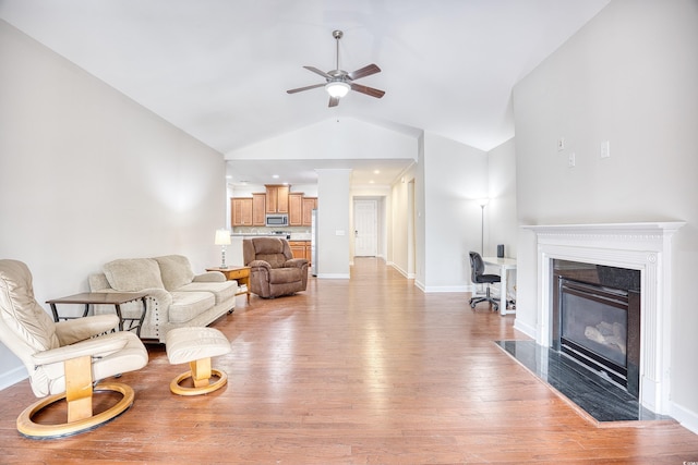 living room featuring high vaulted ceiling, ceiling fan, and light hardwood / wood-style flooring