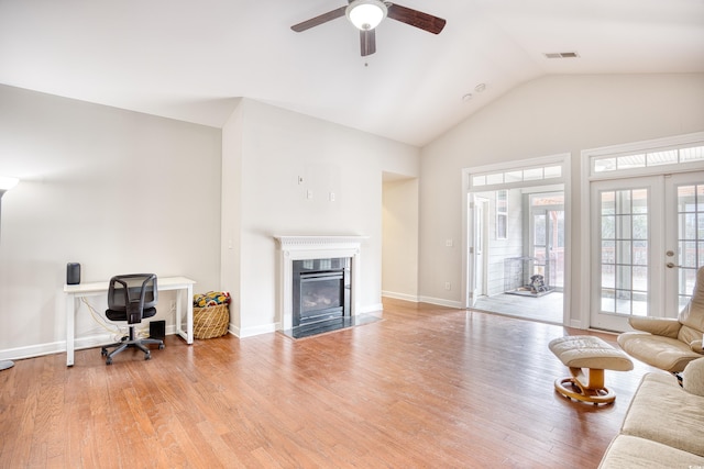 living room with vaulted ceiling, light hardwood / wood-style floors, french doors, and ceiling fan