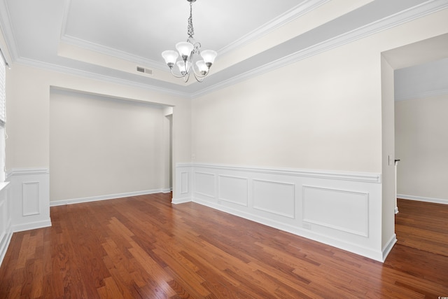 1537 Beaumont Way, Myrtle Beach, SC 29577 - unfurnished room with a chandelier, wood finished floors, a wainscoted wall, ornamental molding, and a tray ceiling