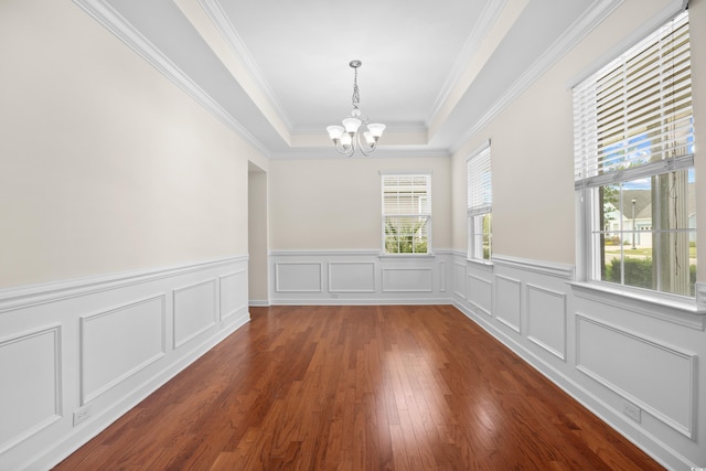 1537 Beaumont Way, Myrtle Beach, SC 29577 - unfurnished dining area featuring a chandelier, healthy amount of natural light, ornamental molding, a wainscoted wall, and wood-type flooring
