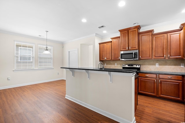 1537 Beaumont Way, Myrtle Beach, SC 29577 - kitchen with appliances with stainless steel finishes, a breakfast bar, dark countertops, decorative backsplash, and crown molding
