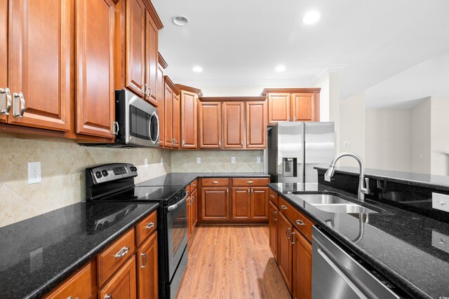 1537 Beaumont Way, Myrtle Beach, SC 29577 - kitchen featuring stainless steel appliances, a sink, light wood-style floors, brown cabinets, and ornamental molding