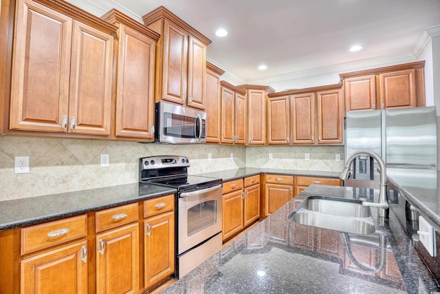 kitchen with tasteful backsplash, appliances with stainless steel finishes, sink, and dark stone counters