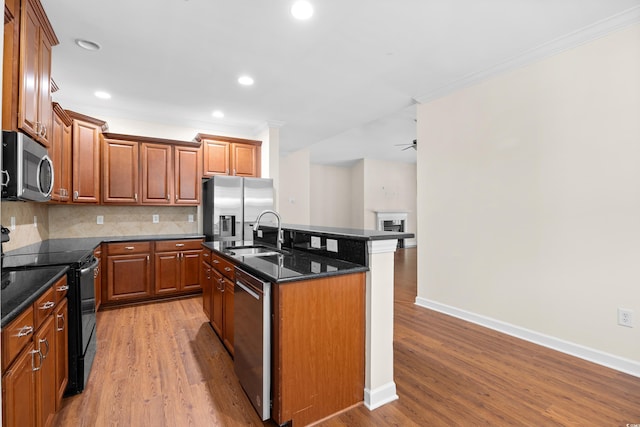 1537 Beaumont Way, Myrtle Beach, SC 29577 - kitchen featuring stainless steel appliances, a sink, crown molding, light wood-style floors, and an island with sink