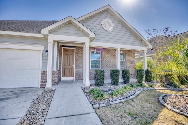 1537 Beaumont Way, Myrtle Beach, SC 29577 - property entrance featuring brick siding, a garage, and covered porch