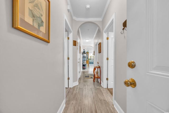 hallway with crown molding and light wood-type flooring