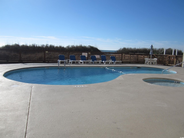 view of pool with a patio and a community hot tub