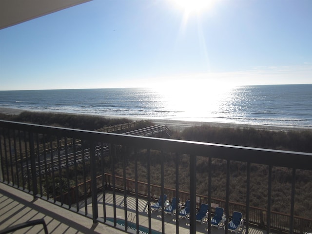 balcony featuring a water view and a view of the beach