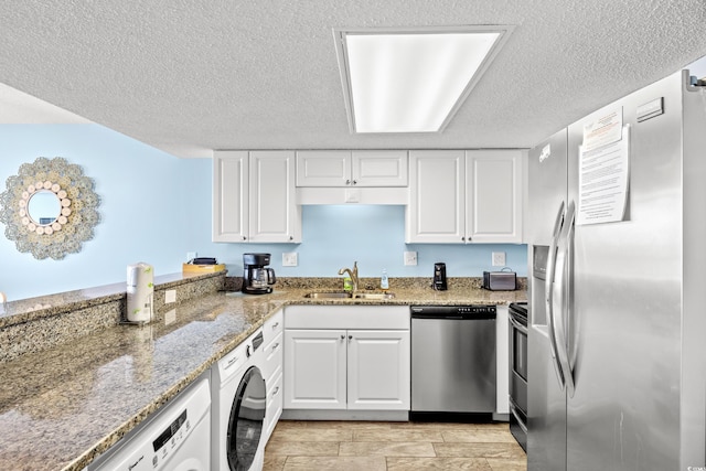 kitchen featuring sink, stainless steel appliances, white cabinetry, and washer / dryer