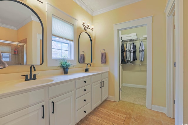 bathroom with crown molding, vanity, and a shower with door