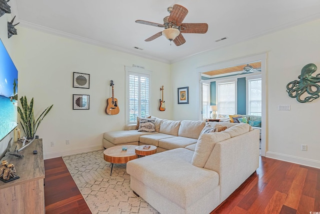 living room featuring ceiling fan, ornamental molding, a healthy amount of sunlight, and hardwood / wood-style floors