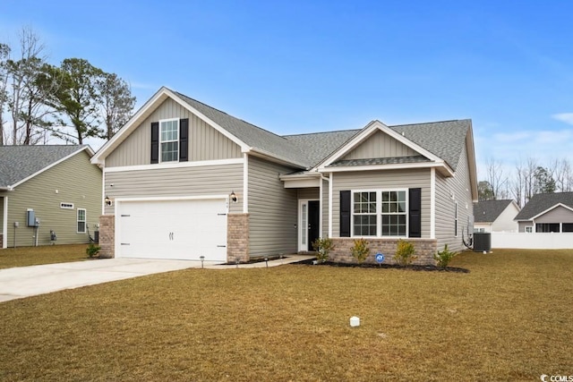 craftsman inspired home with central AC unit, concrete driveway, a front yard, board and batten siding, and brick siding