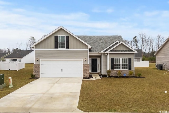 craftsman inspired home featuring driveway, a front lawn, and fence