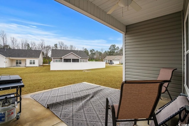 view of patio with ceiling fan, a residential view, and fence