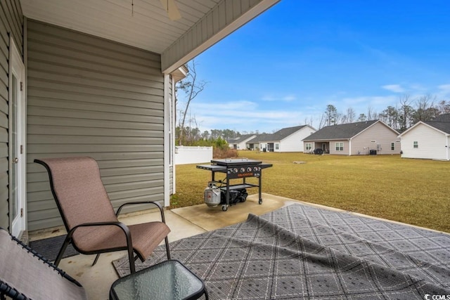 view of patio / terrace featuring ceiling fan and a residential view