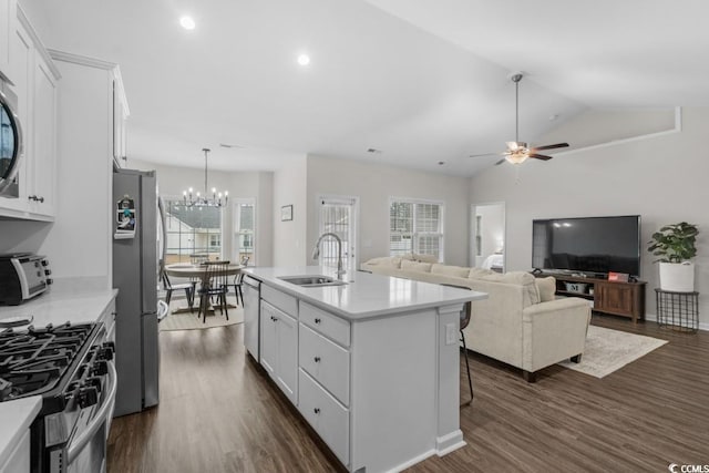 kitchen featuring a center island with sink, white cabinets, stainless steel appliances, light countertops, and a sink