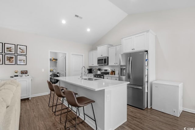 kitchen featuring stainless steel appliances, light countertops, and white cabinetry