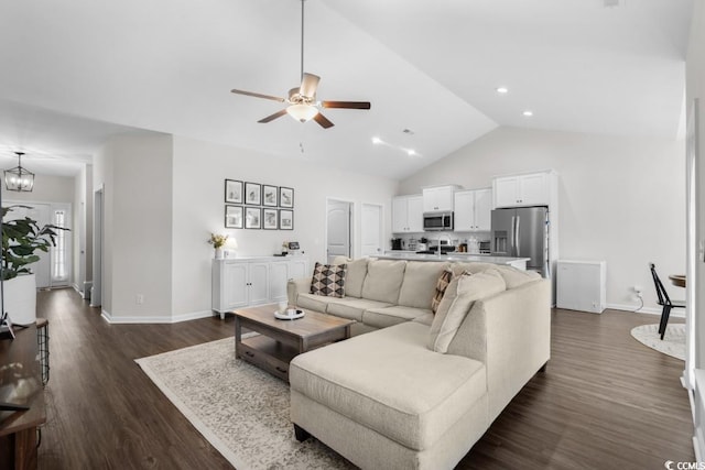 living area with dark wood-style floors, recessed lighting, high vaulted ceiling, baseboards, and ceiling fan with notable chandelier