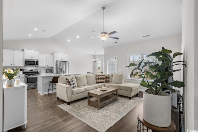 living room featuring a toaster, dark wood finished floors, recessed lighting, visible vents, and ceiling fan with notable chandelier