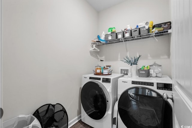 washroom featuring laundry area, washing machine and dryer, and baseboards