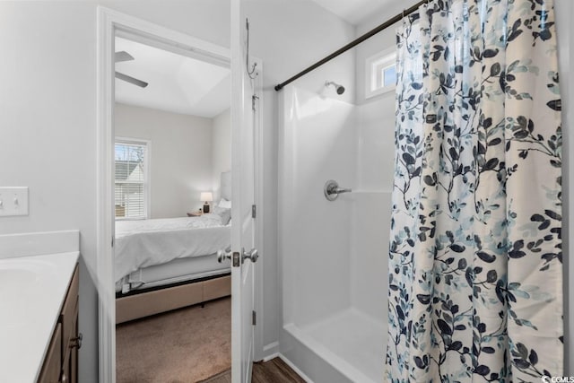 ensuite bathroom featuring a healthy amount of sunlight, a stall shower, vanity, and ensuite bathroom