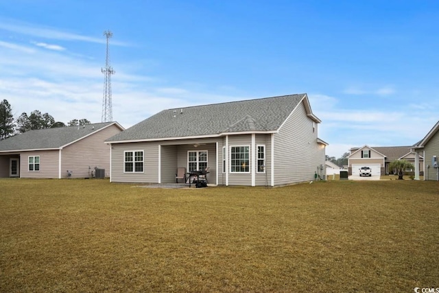 rear view of property with central AC, a lawn, a patio, and roof with shingles