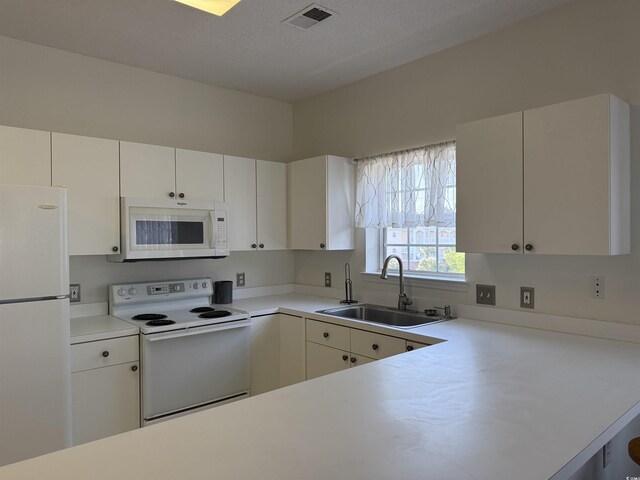 3955 Gladiola Ct Unit 301, Myrtle Beach, SC 29588 - kitchen with white appliances, a sink, light countertops, and white cabinetry