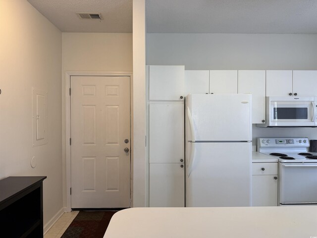 3955 Gladiola Ct Unit 301, Myrtle Beach, SC 29588 - kitchen featuring white appliances, white cabinetry, tile patterned floors, light countertops, and electric panel
