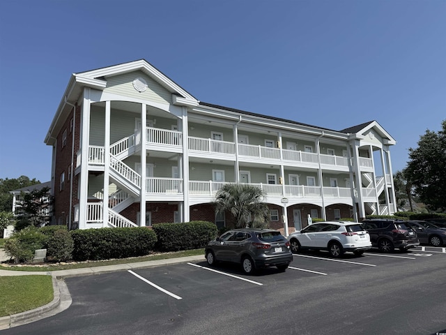 3955 Gladiola Ct Unit 301, Myrtle Beach, SC 29588 - view of building exterior featuring uncovered parking and stairway