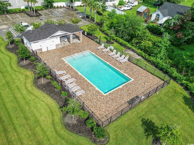 view of swimming pool featuring a yard and a patio area