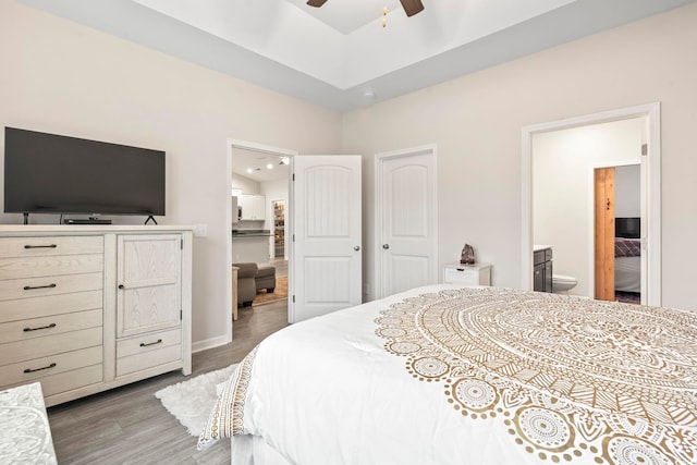 bedroom featuring connected bathroom and hardwood / wood-style floors