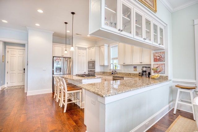 843 Howard Ave, Myrtle Beach, SC 29577 - kitchen featuring stainless steel appliances, a center island, dark wood-type flooring, light stone countertops, and a breakfast bar