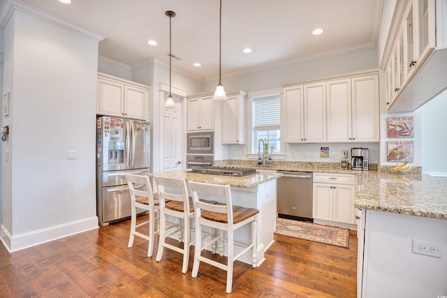 843 Howard Ave, Myrtle Beach, SC 29577 - kitchen with appliances with stainless steel finishes, a kitchen breakfast bar, dark wood-type flooring, a kitchen island, and light stone counters