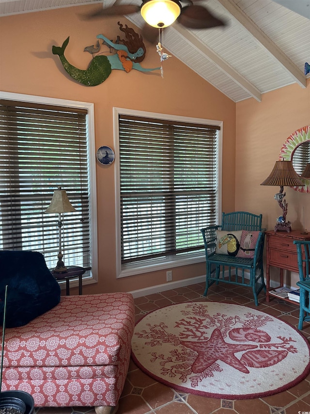 living area featuring tile patterned flooring, vaulted ceiling with beams, and plenty of natural light