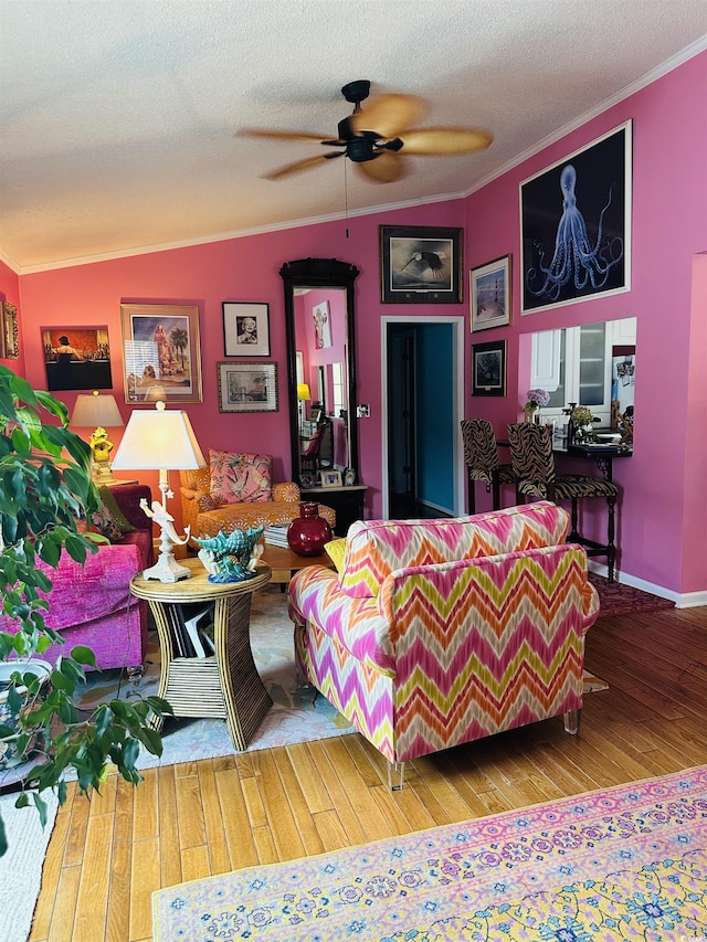 living room featuring ceiling fan, crown molding, a textured ceiling, and hardwood / wood-style flooring